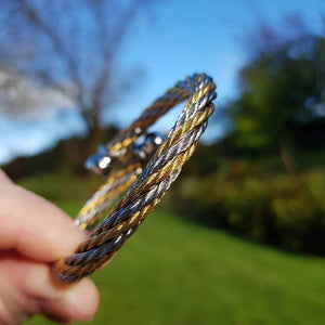 Herspirit flexible steel and gold tone bangle - approx diameter 6.5cm - Callibeau Jewellery